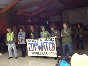 After the death of Kayla Moore, Berkeley Cop Watch stands watch at a police forum. 